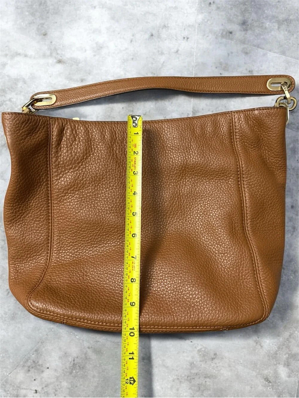 Michael Kors Cognac Pebbled Leather Shoulder Bag with Gold logo on the side.